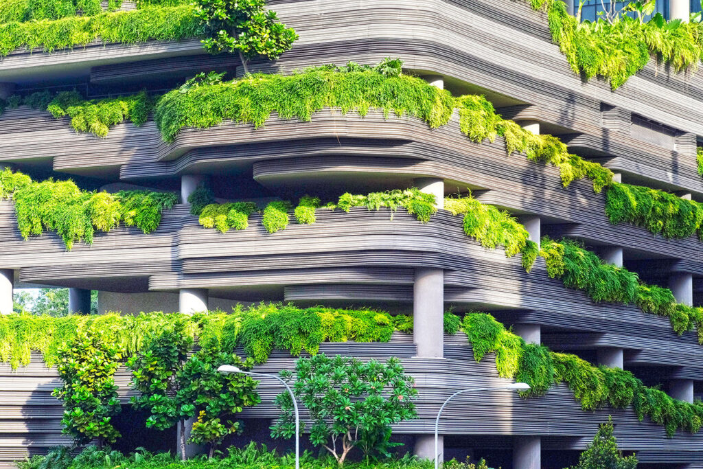 Concrete building covered in green shrubbery