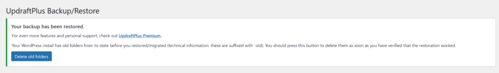 UpdraftPlus admin notice confirming restore completed and button to delete old folders created during restoration